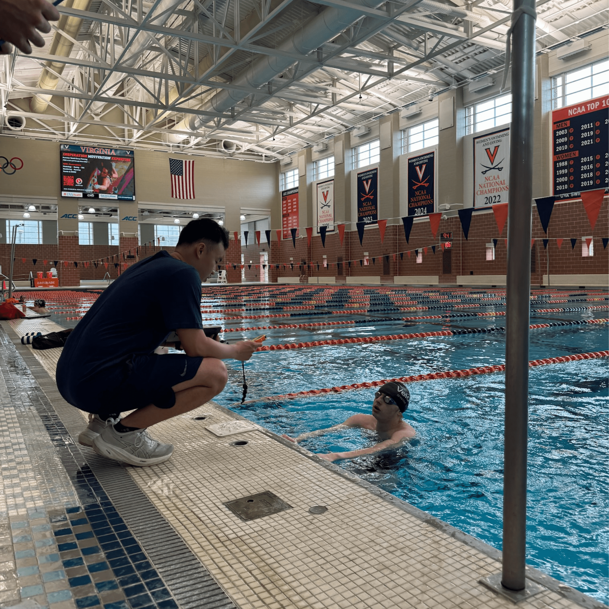 One-on-one coaching session with swimmer receiving personalized instruction