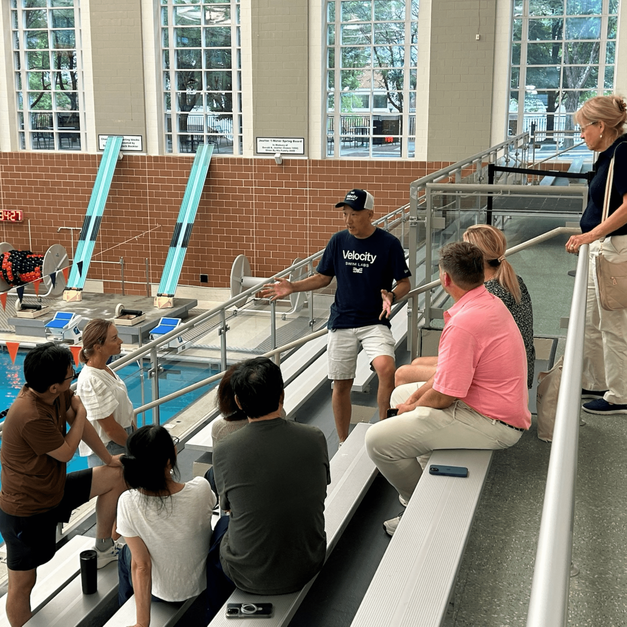 Dr. Ken Ono presenting swim analysis to parents and attendees