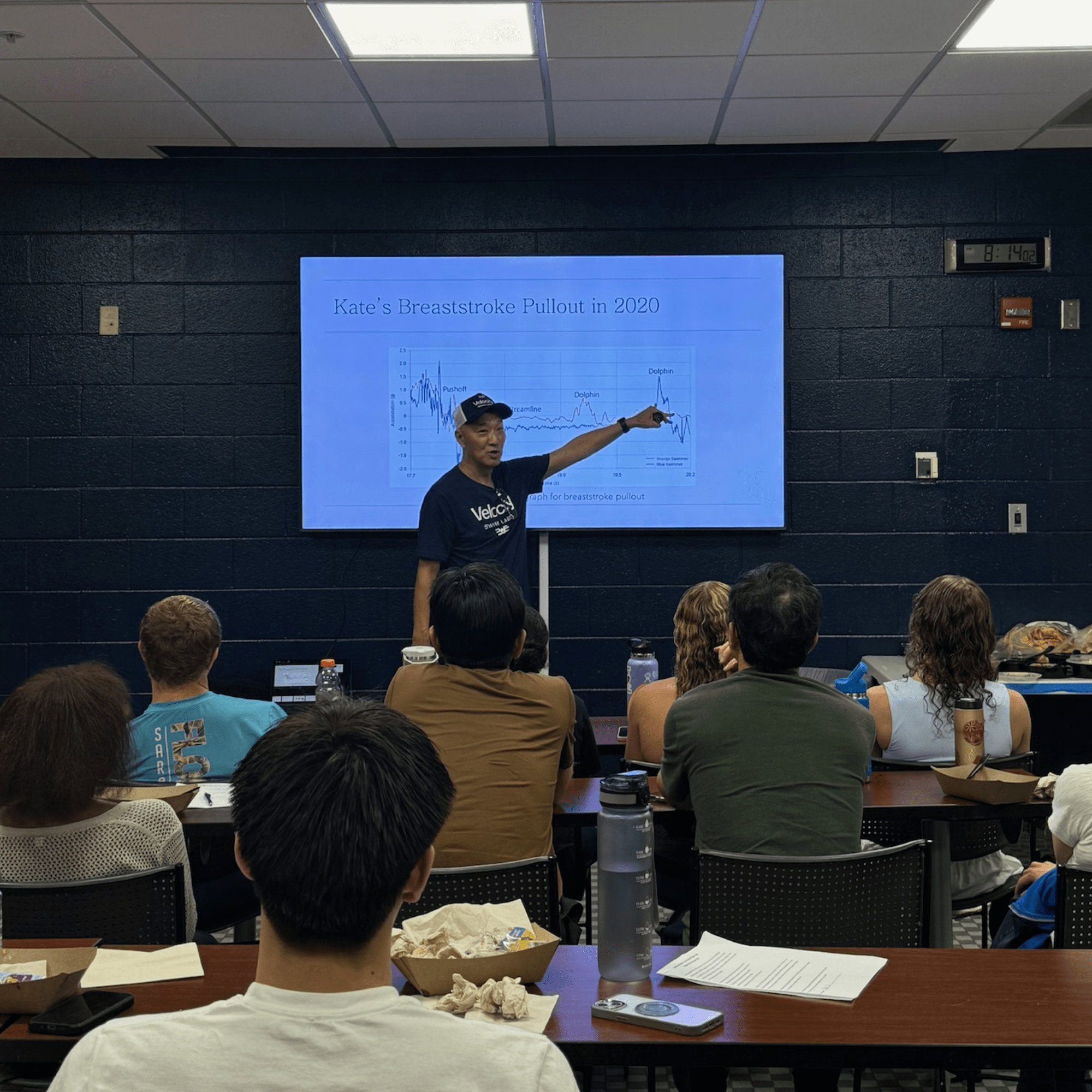 Dr. Ken Ono presenting Kate's breaststroke pullout data analysis to audience